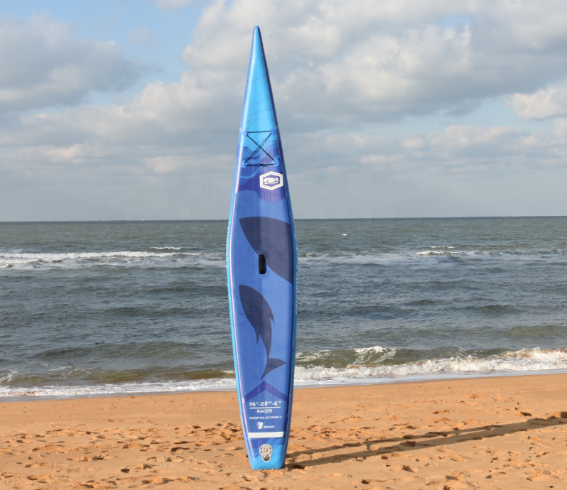 Blue half V-hull full-print race inflatable SUP paddleboard front view on a sandy beach